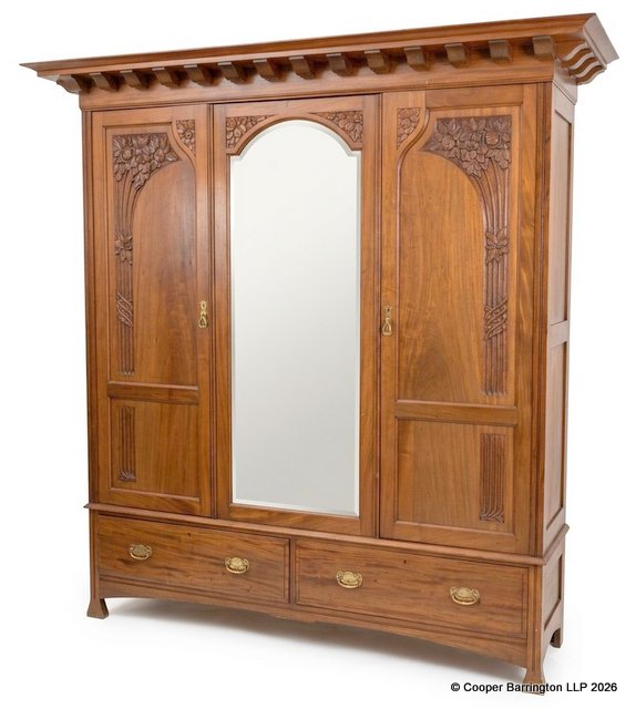 Antique Art Nouveau Triple Wardrobe Crafted from Solid Walnut.  Early 1900. Featuring a deep cornice, floral carved doors and a central mirror panel over a 2 drawer base all raised on stylised legs