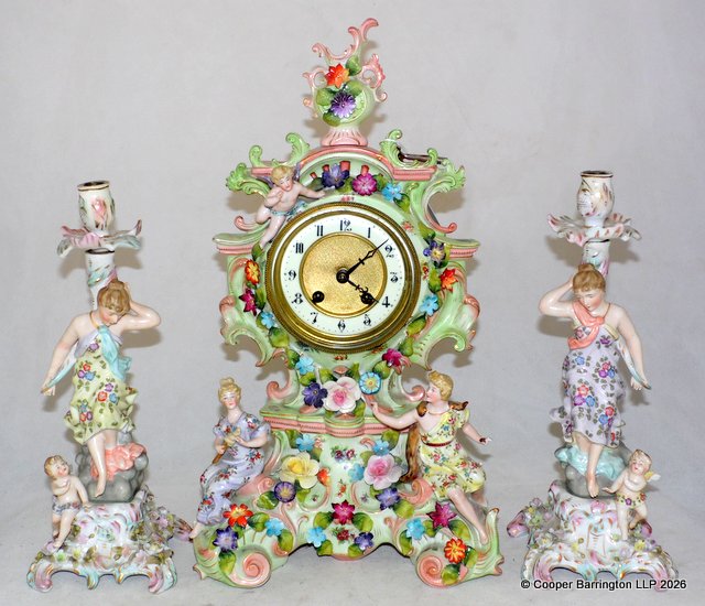 Antique HAC German Dresden Style Cherub Floral Mantle Clock with Candlesticks Set. Circa 1890s. Having 8 day movement with porcelain dial and Arabic numerals striking on a bell (Missing). Working order with pendulum and key. The porcelain has a few small losses. Height 45 cm. Antique HAC German Dresden Style Cherub Floral Mantle Clock with Candlesticks Set. Circa 1890s. Having 8 day movement with porcelain dial and Arabic numerals striking on a bell (Missing). Working order with pendulum and key. The porcelain has a few small losses. Height 45 cm.